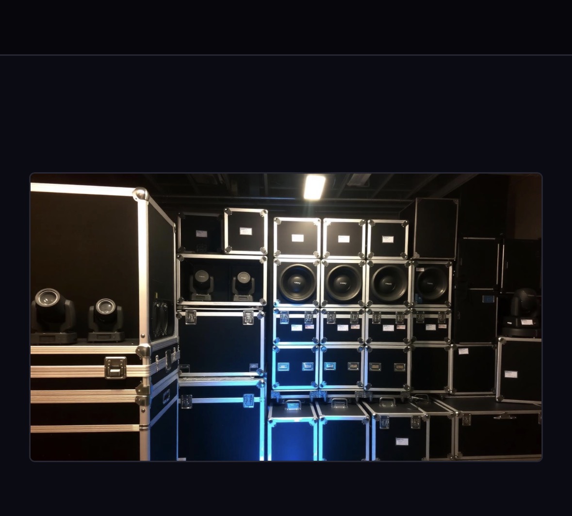 Flight-cased speakers, moving heads and power distro ready to load out for an event