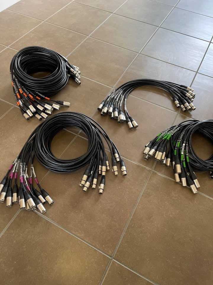 Colour-coded multicore XLR audio looms coiled and ready to load